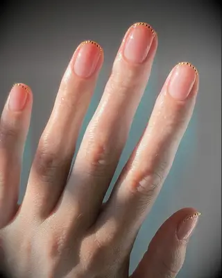 Tiny gold gemstone french manicure 