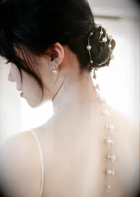 Twisted updo wedding hair trend with pearls