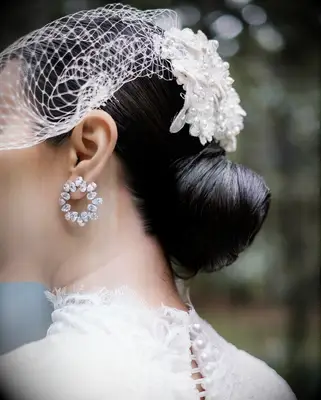 Accessorized bun wedding hairstyle for high neck dress