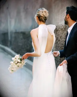 Double twisted bun high neck dress wedding hairstyle