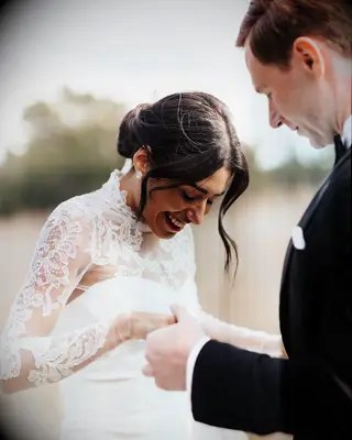 Loose waves bun high neck dress wedding hairstyle 