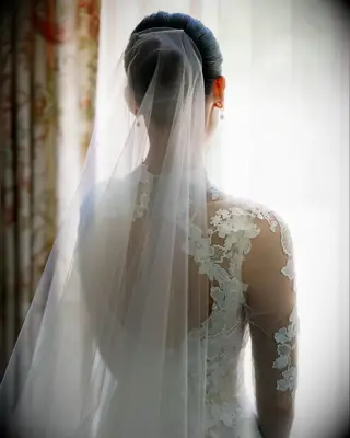 Sock bun high neck dress wedding hairstyle