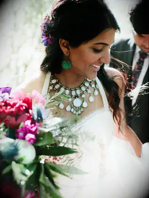 boho wedding hair half up half down with braids and colorful flowers
