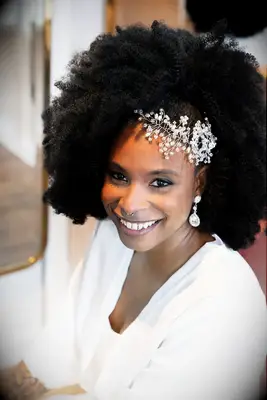 Natural curls with side clip wedding hairstyle