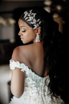 Long curls and statement clip formal wedding hairstyle