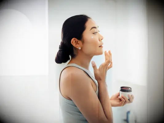 Woman applying skincare products getting rid of acne fast