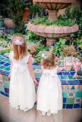 Half up flower girl hairstyle with fresh flowers