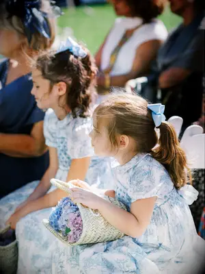 Flower girl ponytail hairstyle with blue bow