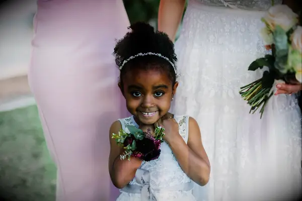 Flower girl wears her hair in a curly bun