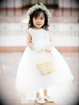Flower girl wears her hair down with a baby