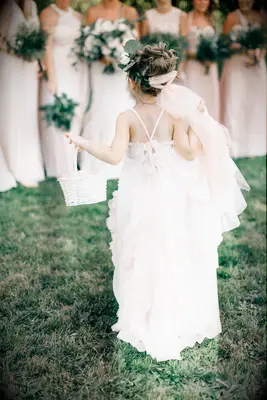 Flower girl wears her hair in a whimsical updo. 