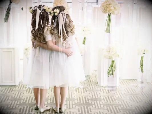 Flower girls wear their hair in loose curls complete with flower crowns. 