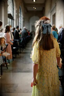 Flower girl hairstyle with blue bow and flowers