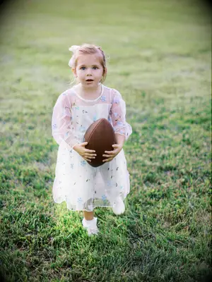 Simple ponytail flower girl hairstyle with white bow