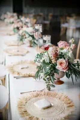 Woven place mates and pink floral centre piece design
