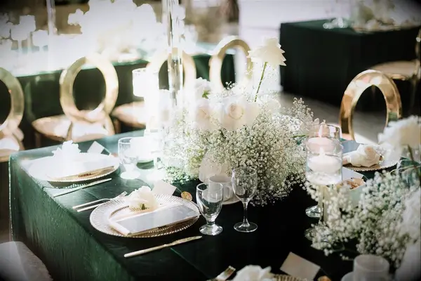 Emerald green table cloth with white flower centre piece