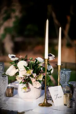 bronze candlestick holders with white floral design