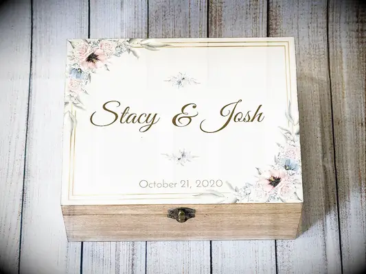 Wooden box and white lid with floral design in corners and couple
