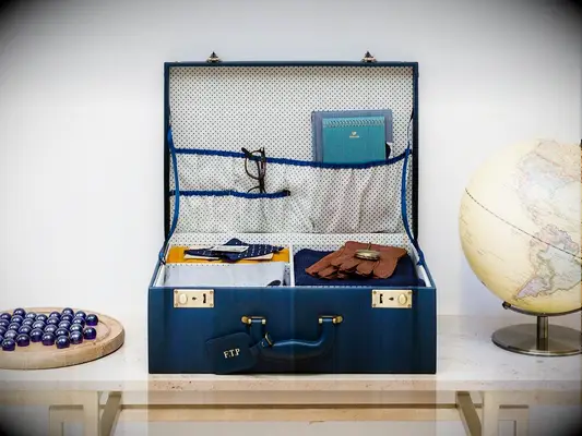 Blue briefcase with sections and pockets inside and brass latches