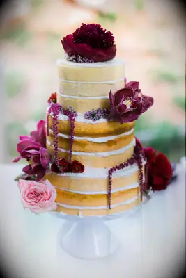 three tier naked wedding cake with vanilla sponge, burgundy amaranthus, orchids and pink rose