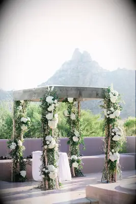 Wooden four pillar arch with flowers