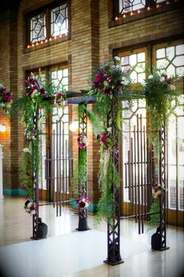 Indoor wood arbor with purple flowers