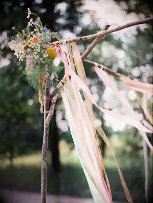 Rustic ribbon and wildflower arbor