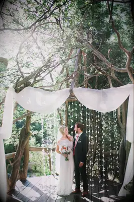 Rustic tree branch ceremony arch