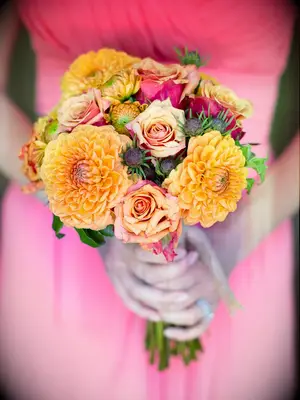 Orange bridesmaid bouquet with dahlias and roses