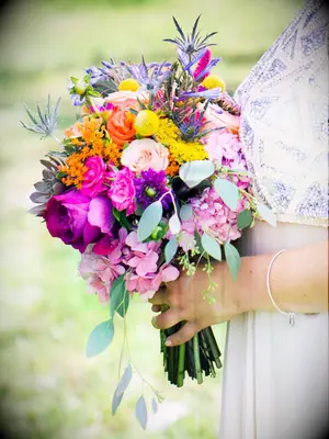Bright wedding bouquet with hydrangea, roses and thistle