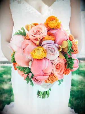 Bright wedding bouquet with roses, ranunculus and peonies