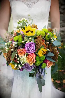 Fall bridal bouquet with sunflowers, roses and chrysanthemums