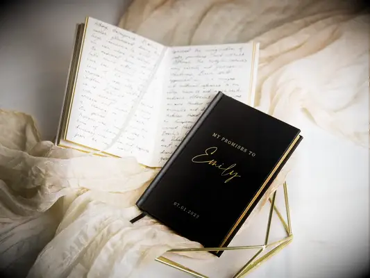 custom vow book with black hardcover and gold lettering