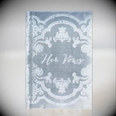 blue velvet vow book with ornate antique scroll design on the cover