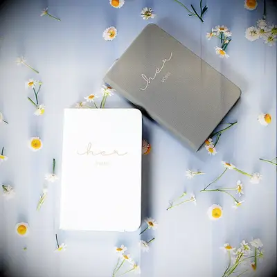 LGBTQ friendly vow books for same sex couple with her vows written in gold lettering on the front of each book