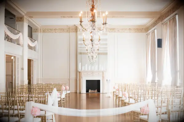 elegant ballroom wedding venue with fireplace decorated with floating candles in glass vases