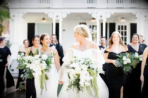 Bride with wedding party walking photo