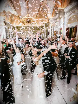 Bride and groom dancing with wedding party at reception