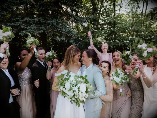 Funny bridesmaid picture with groomsmen and couple
