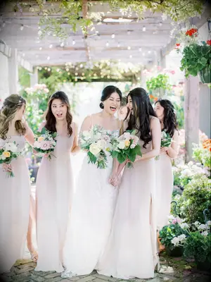 Bridesmaids and bride laughing together