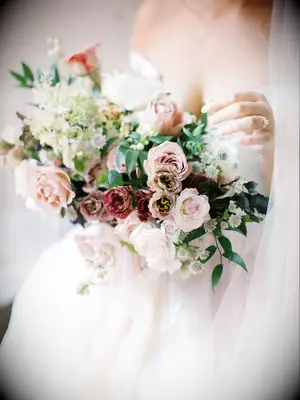 romantic winter wedding bouquet with blush and mauve roses, smilax and white astrantia
