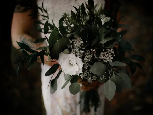 minimalist winter wedding bouquet with white flowers and greenery