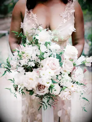 oversized garden style wedding bouquet with blush and ivory roses, jasmine vines, lisianthus, sweet peas and ranunculus