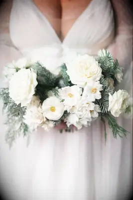 simple winter wedding bouquet with evergreen branches