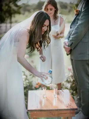 bride taking tequila shot during wedding