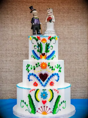 Colorful three-tier cake with skeleton cake topper