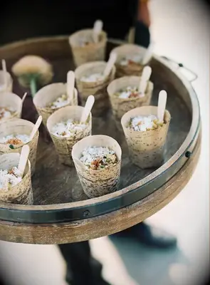 corn salad in bamboo cups on tray