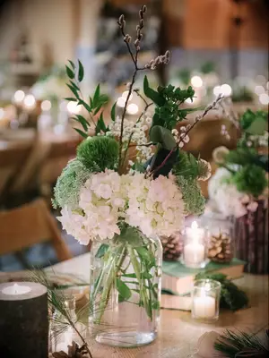 low greenery centerpiece with dianthus, white hydrangea and pussy willow branches