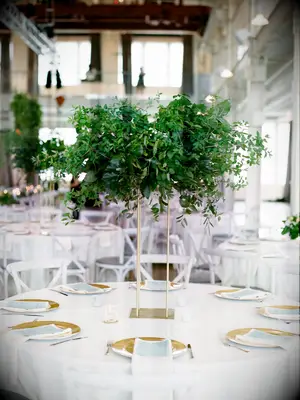 tall greenery wedding centerpiece with gold stand
