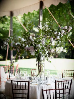 tall wedding centerpiece with greenery branches and foraged white flowers